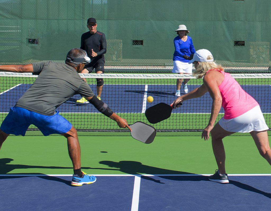 A group plays pickleball