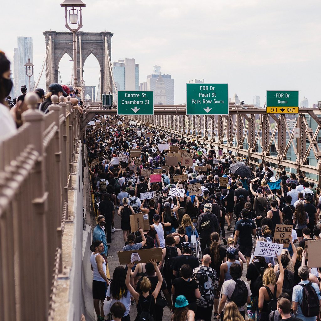 People marching across the Brooklyn Bridge