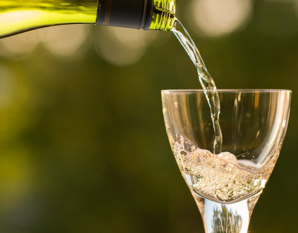person-pouring-white-wine
