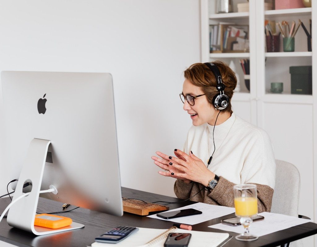 person in home office with headphones on