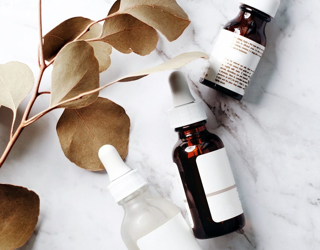 An array of oils and serums on a table.