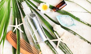 Spray and other beachy items laid out on the beach.
