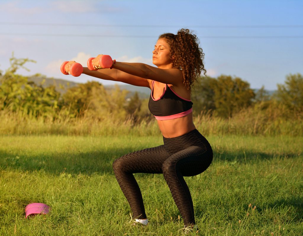 A woman working out outside.