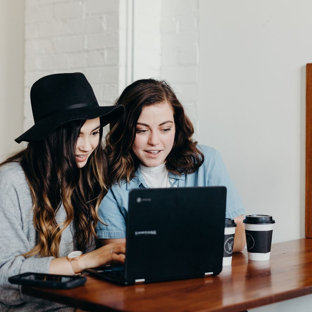 Two women looking at a computer