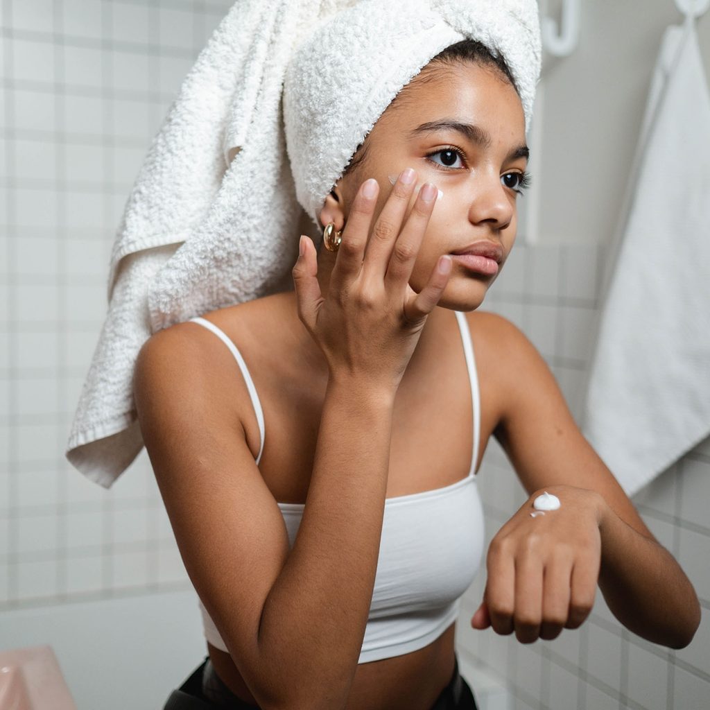 Woman applying face cream