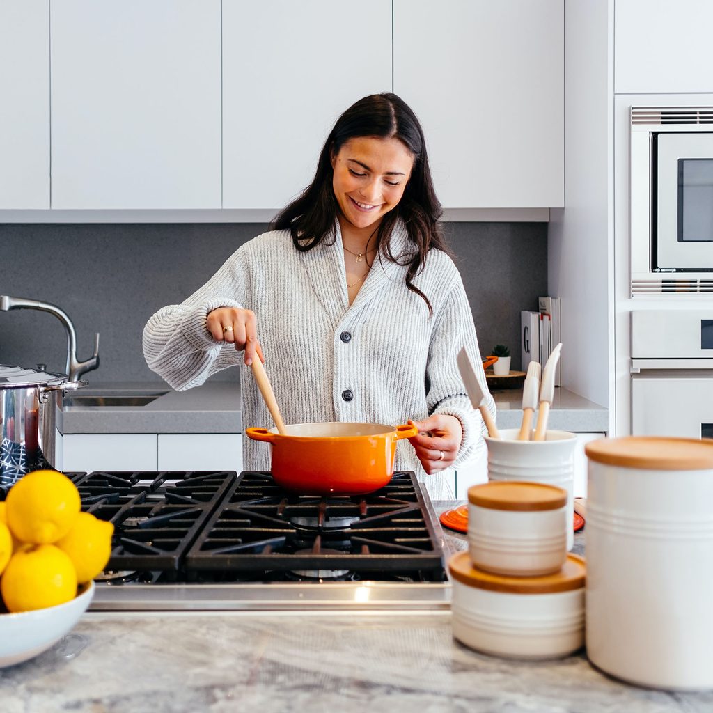 Woman cooking with a saucepan