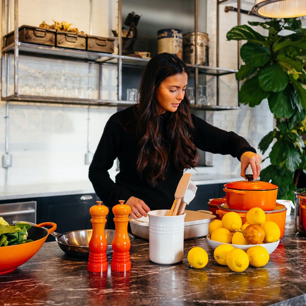 Woman cooking with orange cookware
