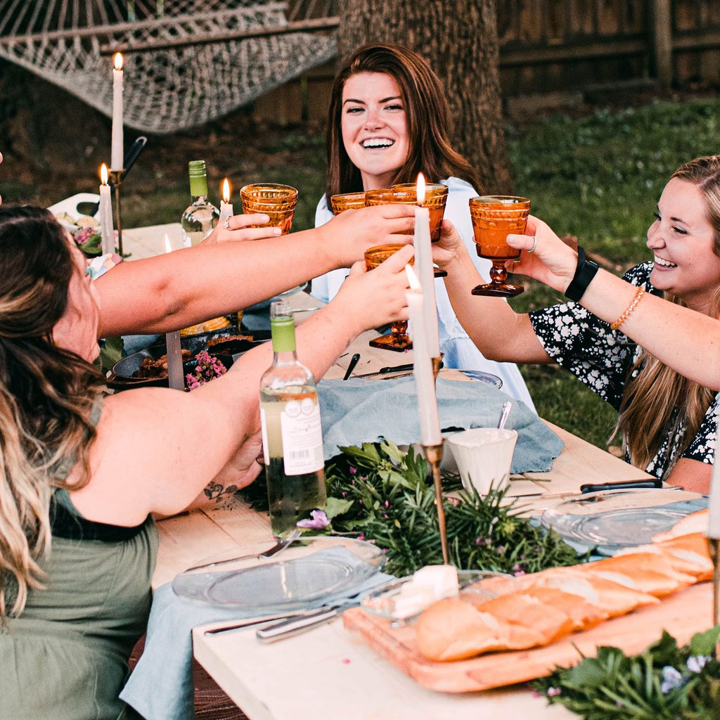Friends toasting at an outdoor party