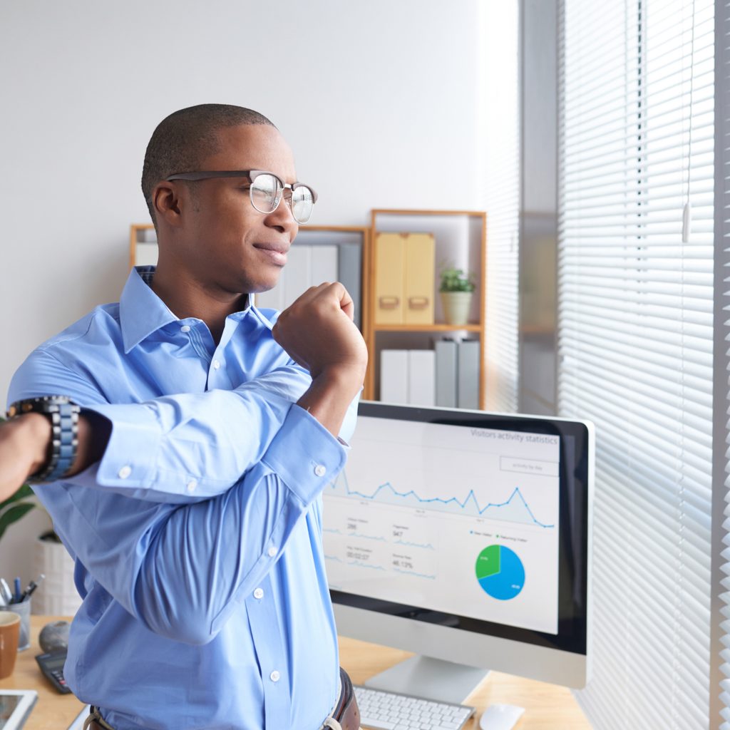 Man stretching while taking a break from work