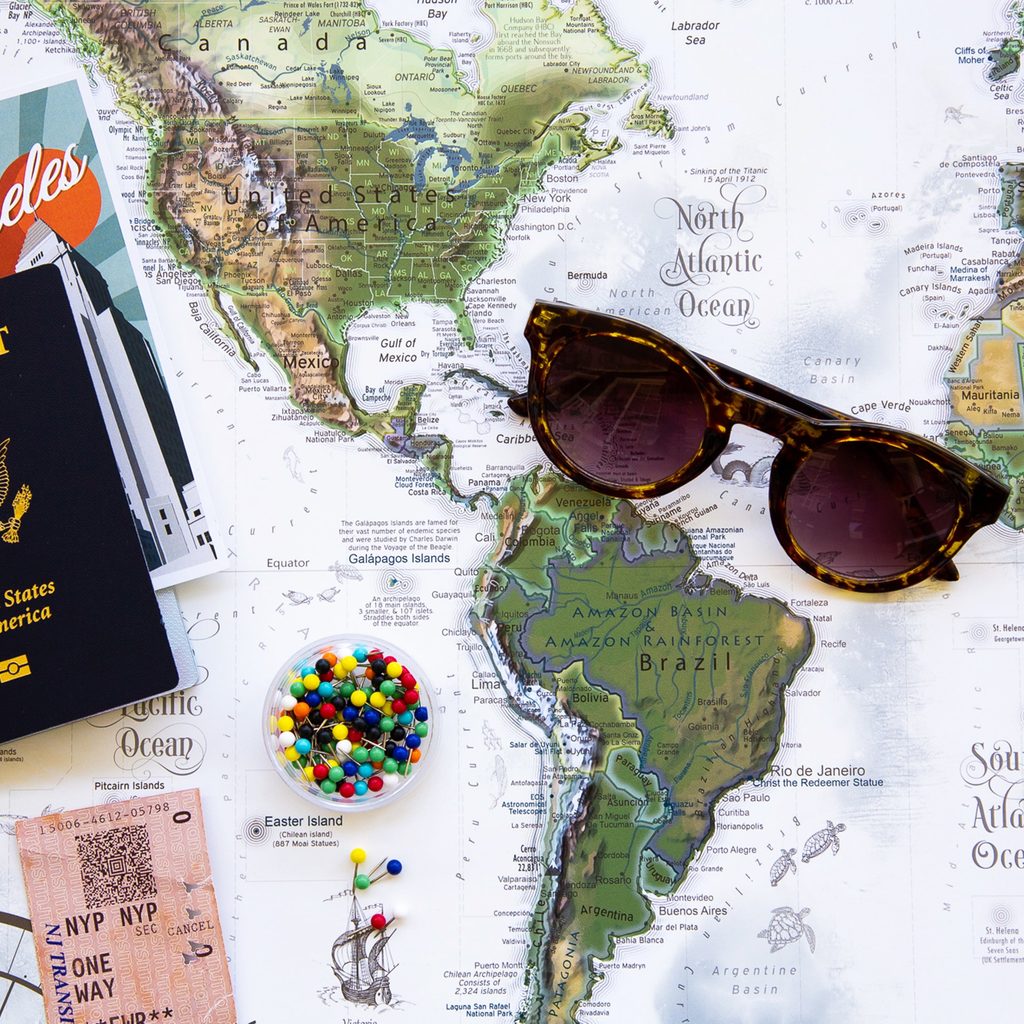 Passport on map with sunglasses