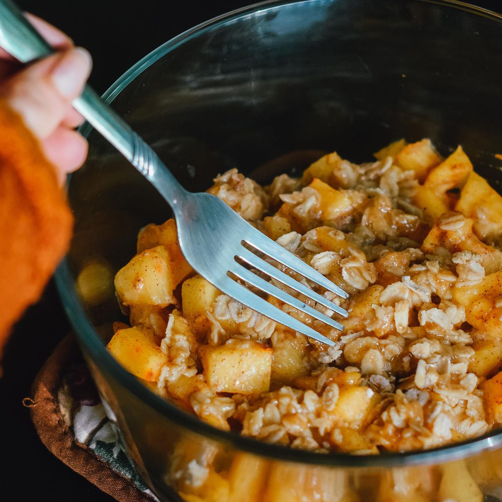 Person eating peach cobbler
