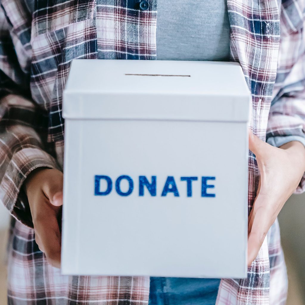 Person holding a donation box
