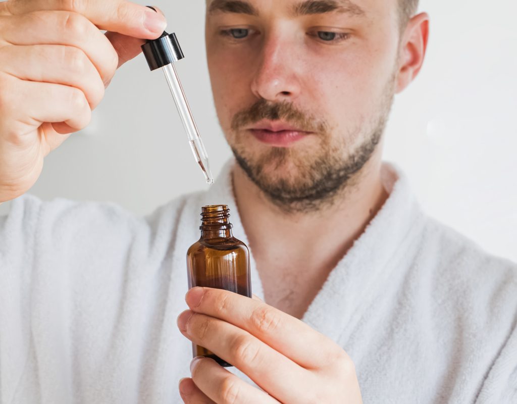 A man looking at beard oil.