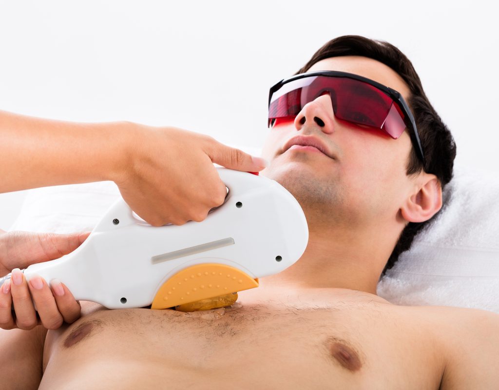 A man getting laser hair removal on his chest.