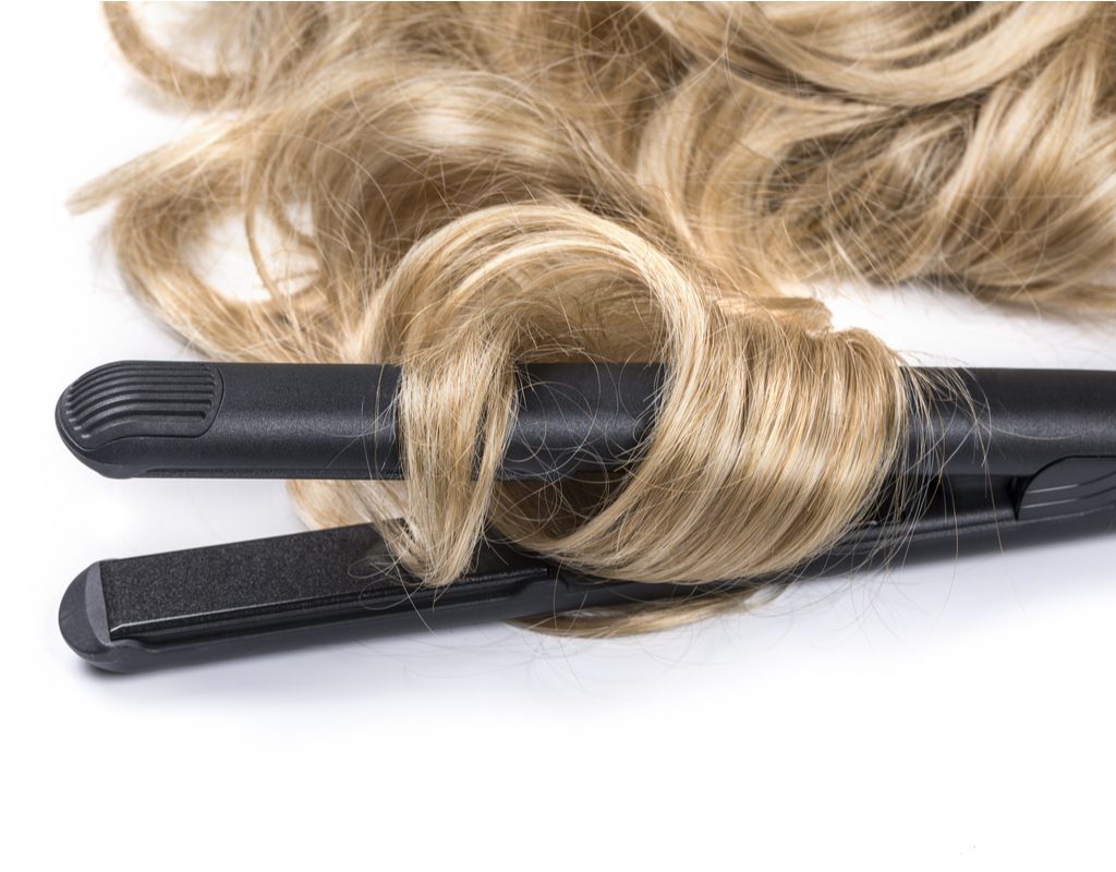 Curled hair wrapped around a flat iron.