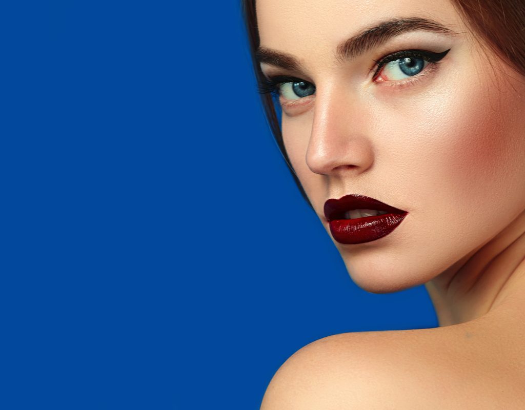 A woman with a bold burgundy lipstick.