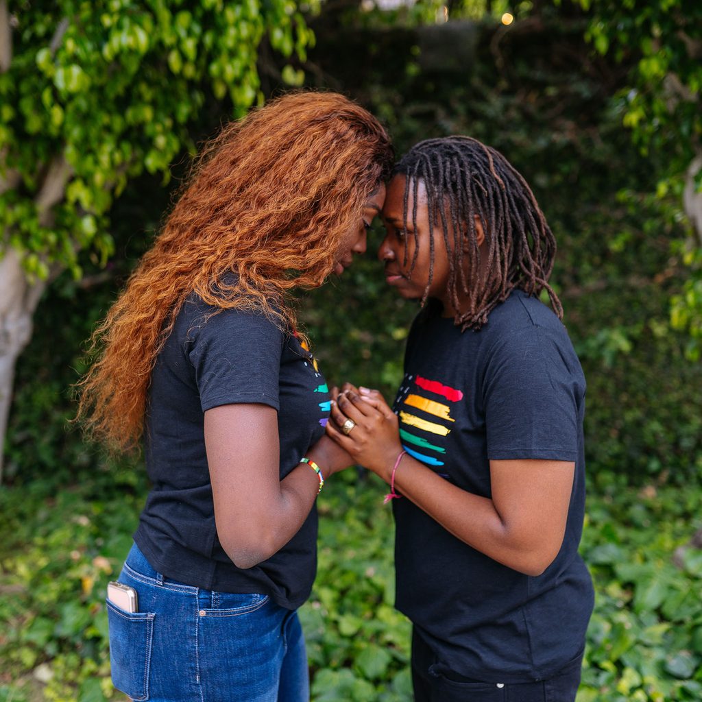 Two people holding hands outside