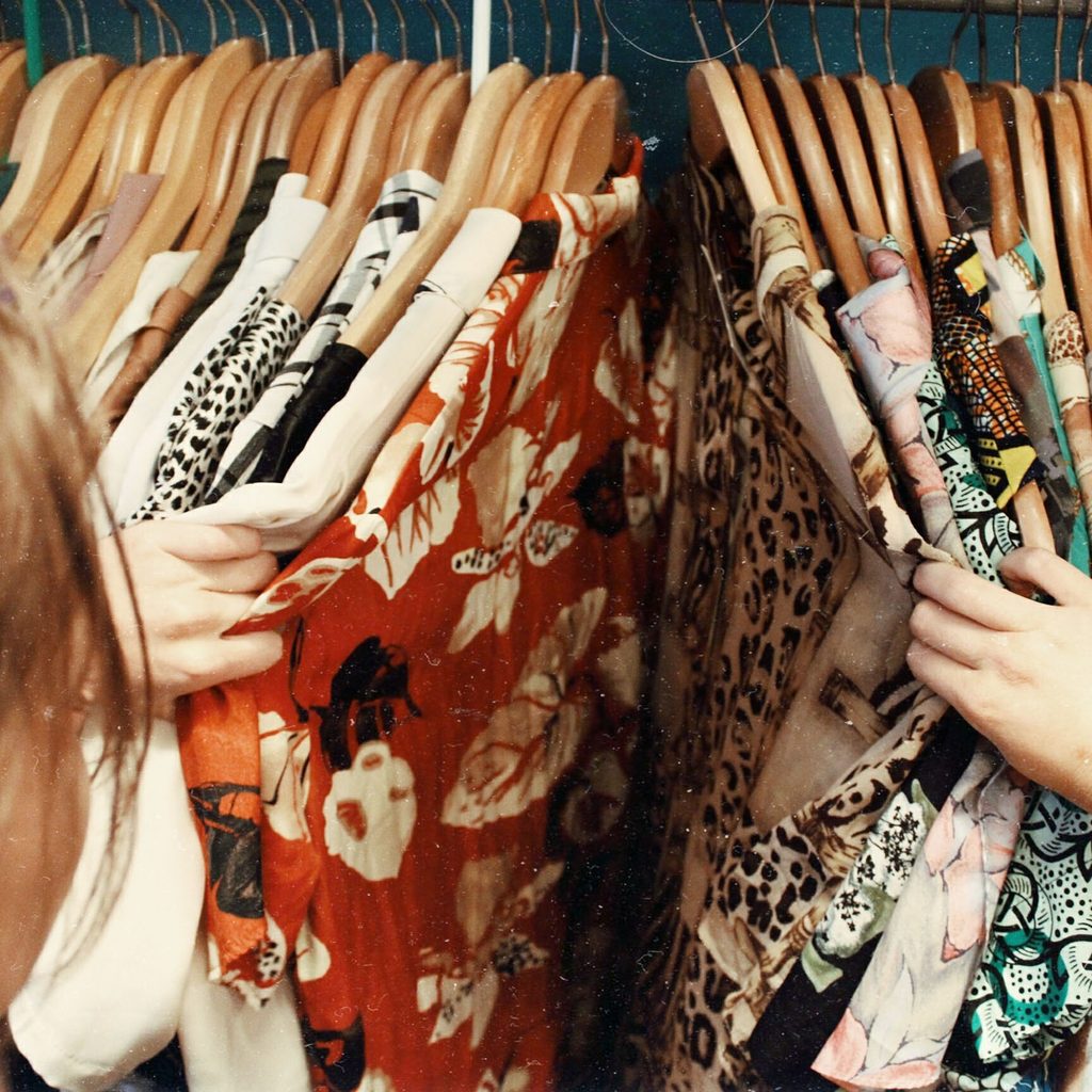 Woman browsing clothes at a thrift store