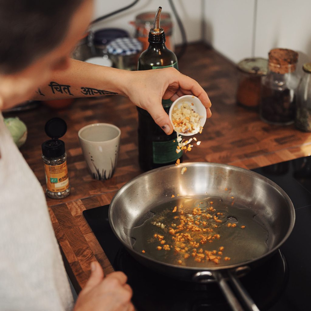 Woman frying food on the stove