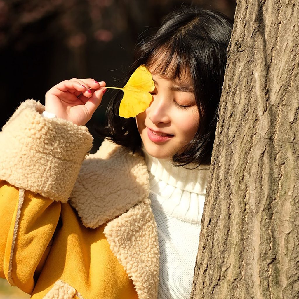 Woman in a fuzzy jacket and knit sweater