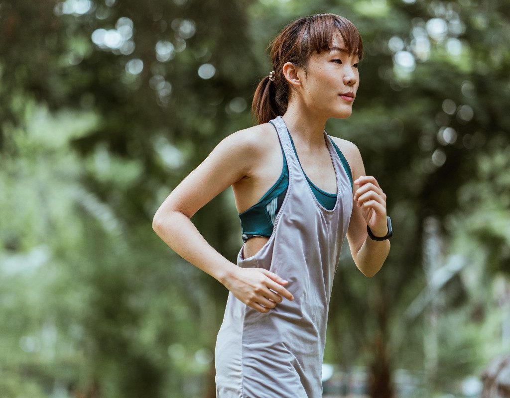 a woman on a morning run through a park
