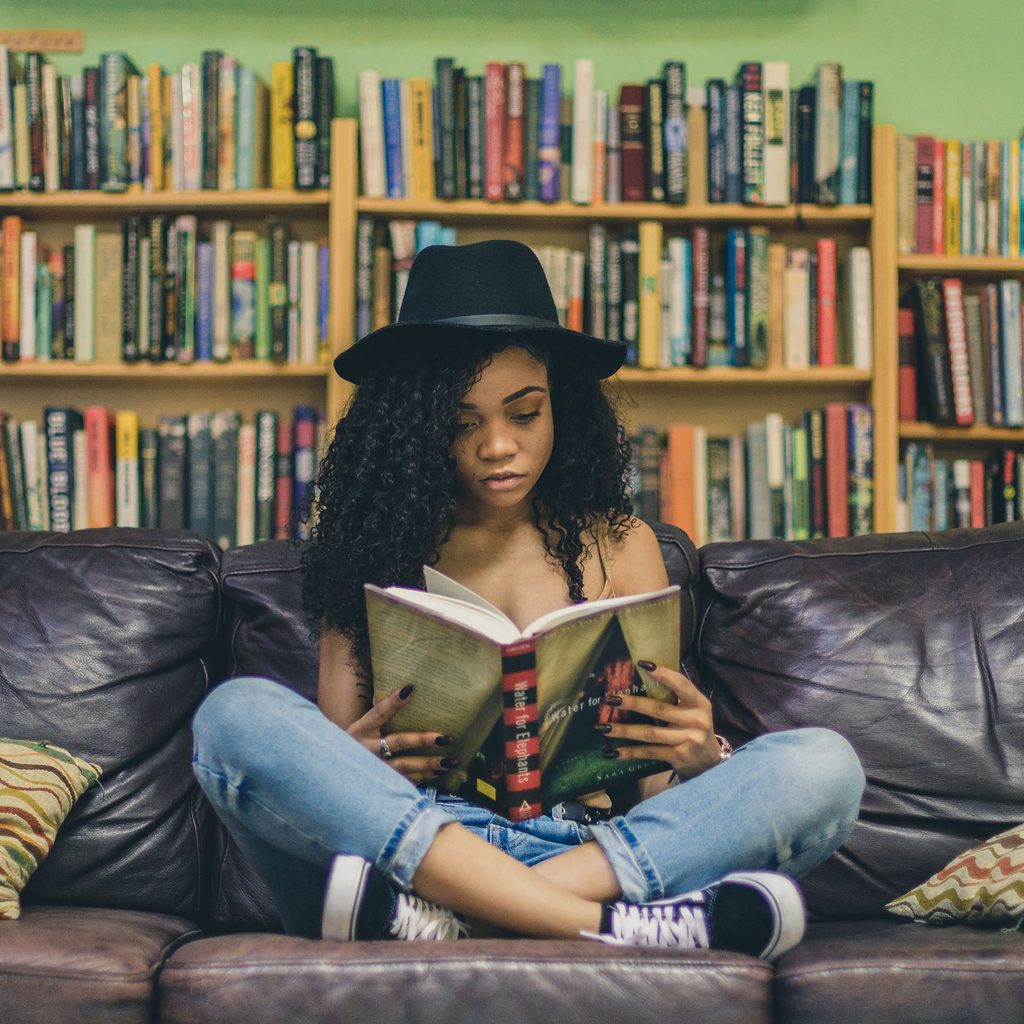Woman sitting on a couch and reading