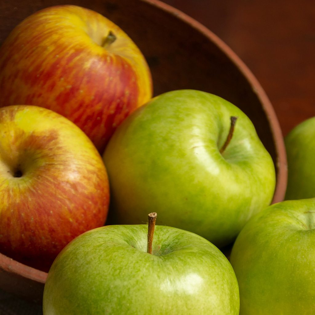 Green and red apples in a bowl