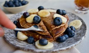 pancakes on a plate with berries and bananas