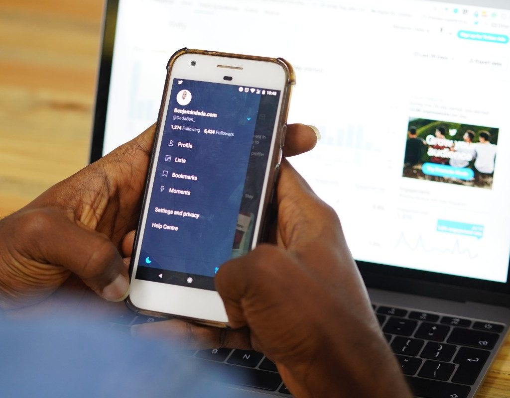 a person looking at twitter while sitting at a desk