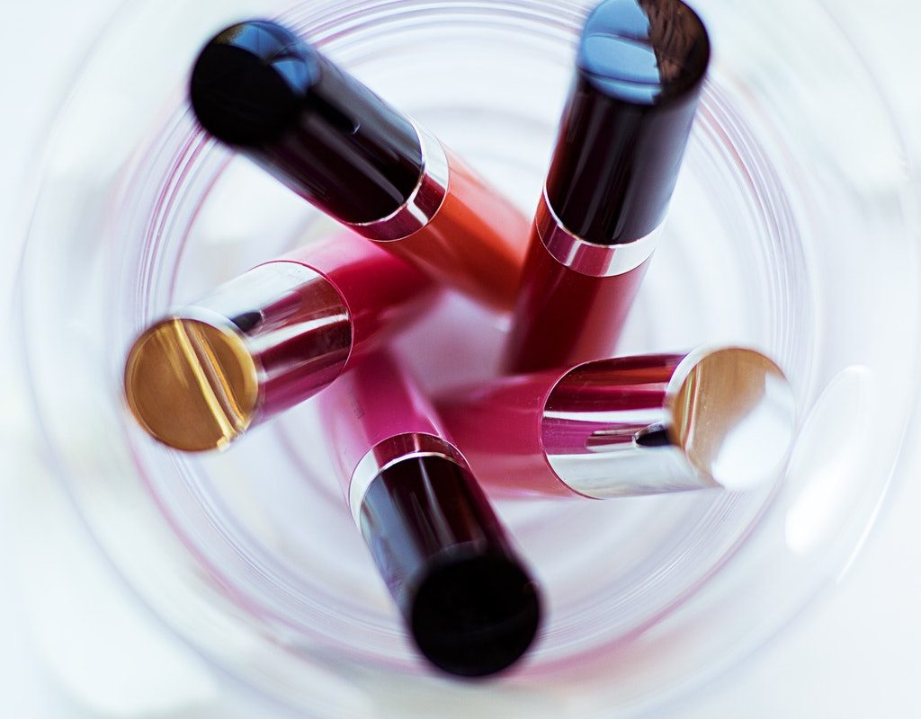 Lipsticks in a clear cup.