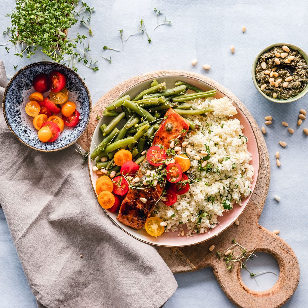 Quinoa bowl with salmon, tomatoes, and beans