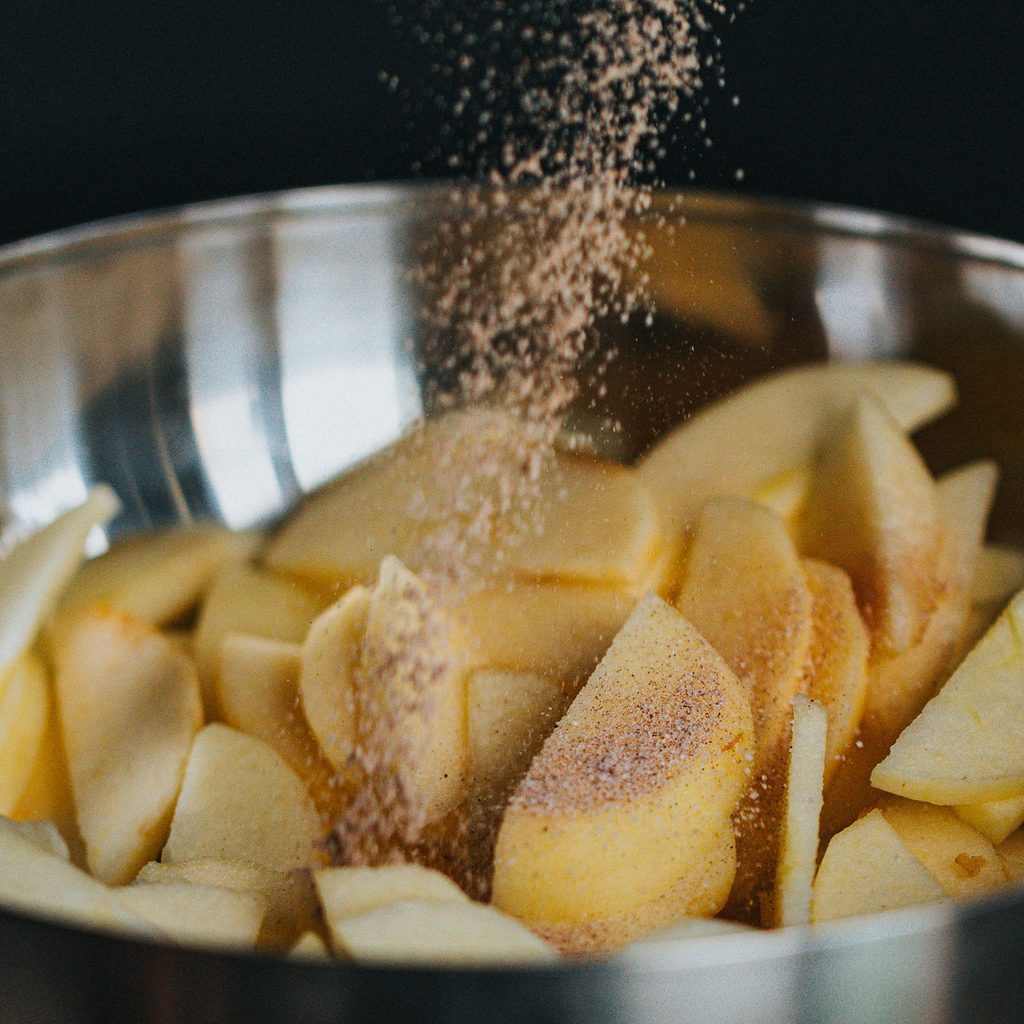 Seasoned apples in a metal bowl