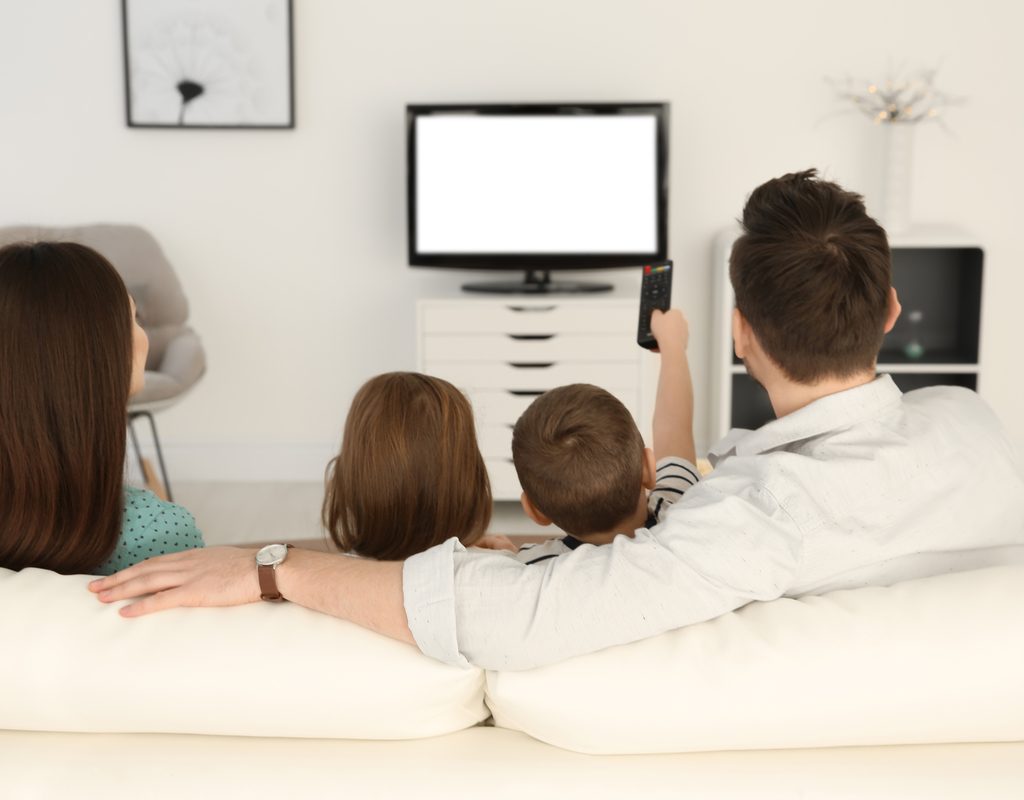 A family on the couch about to watch a movie.