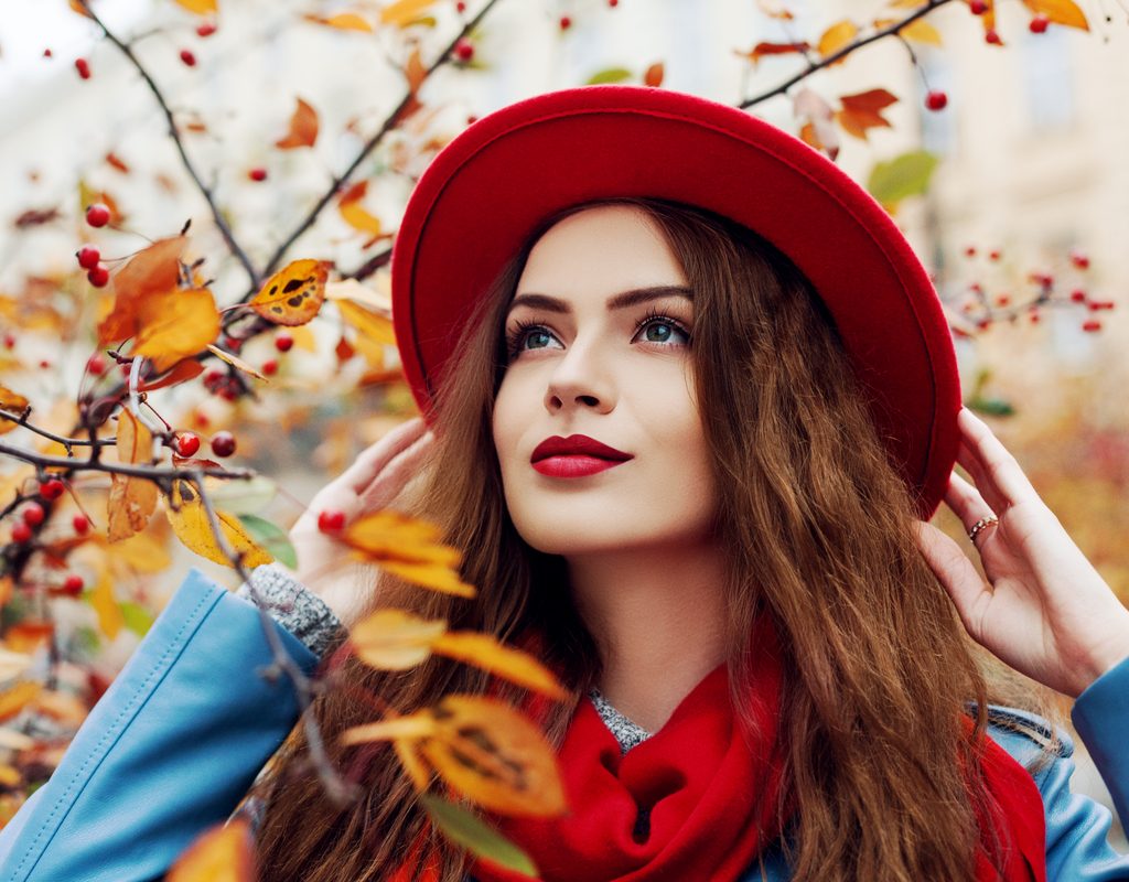 A woman in fall fashion and makeup.