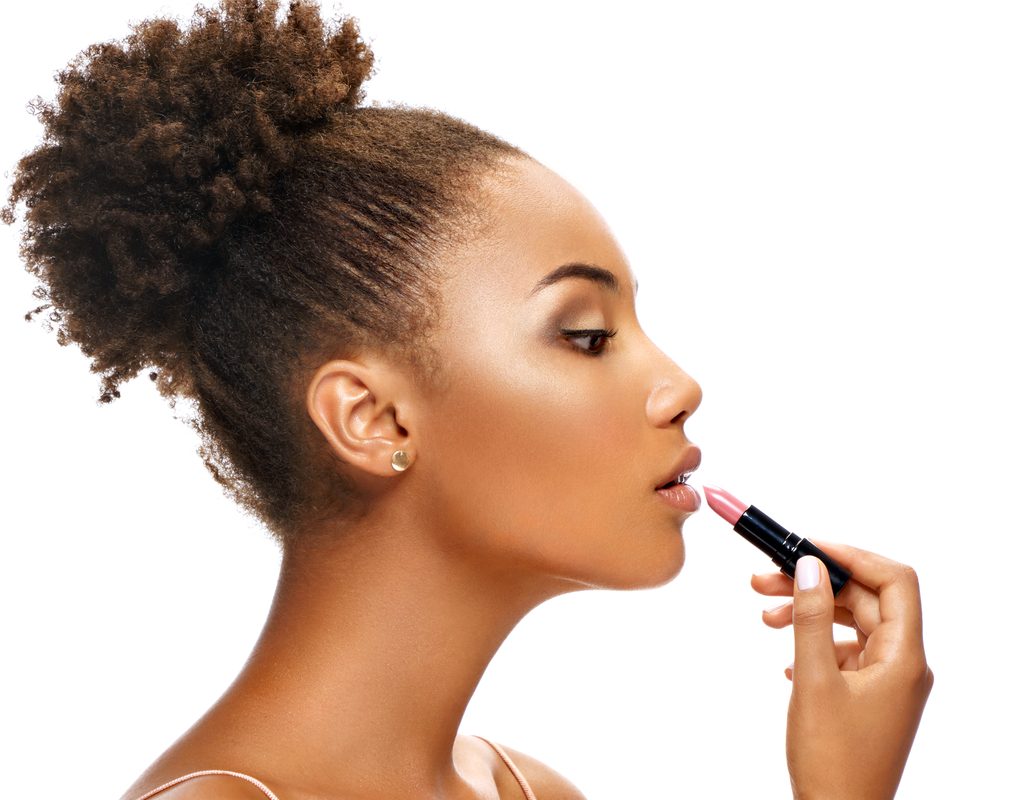 A woman putting on lipstick.