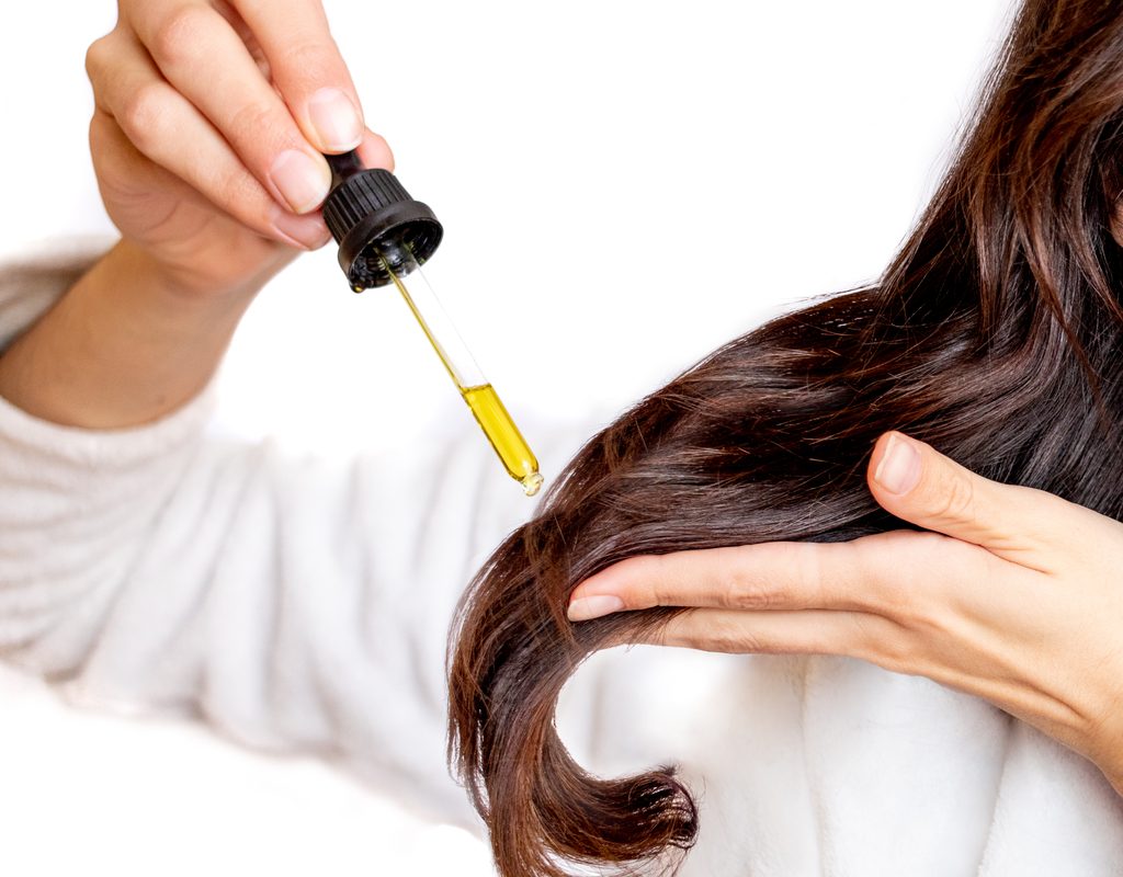 Putting oil in hair.