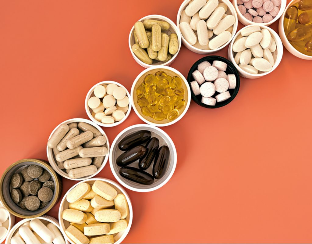 Various vitamins and supplements in little cups.