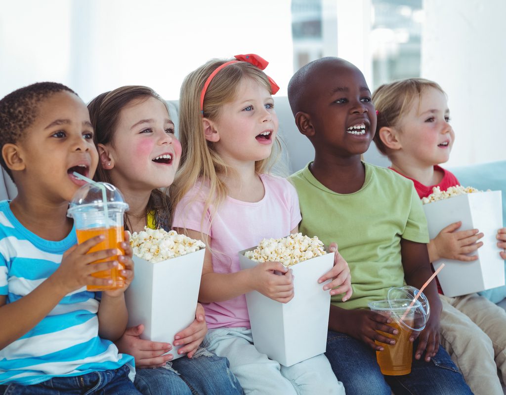 A group of kids watching a movie.