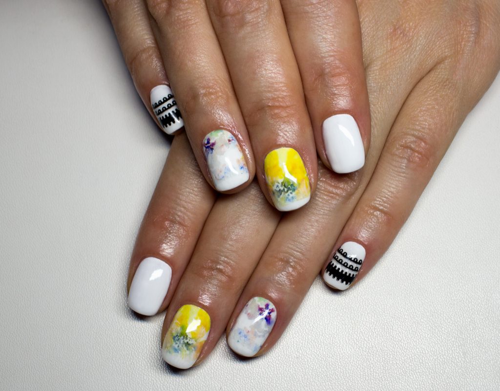 A full set of nails done with beautiful nail art.