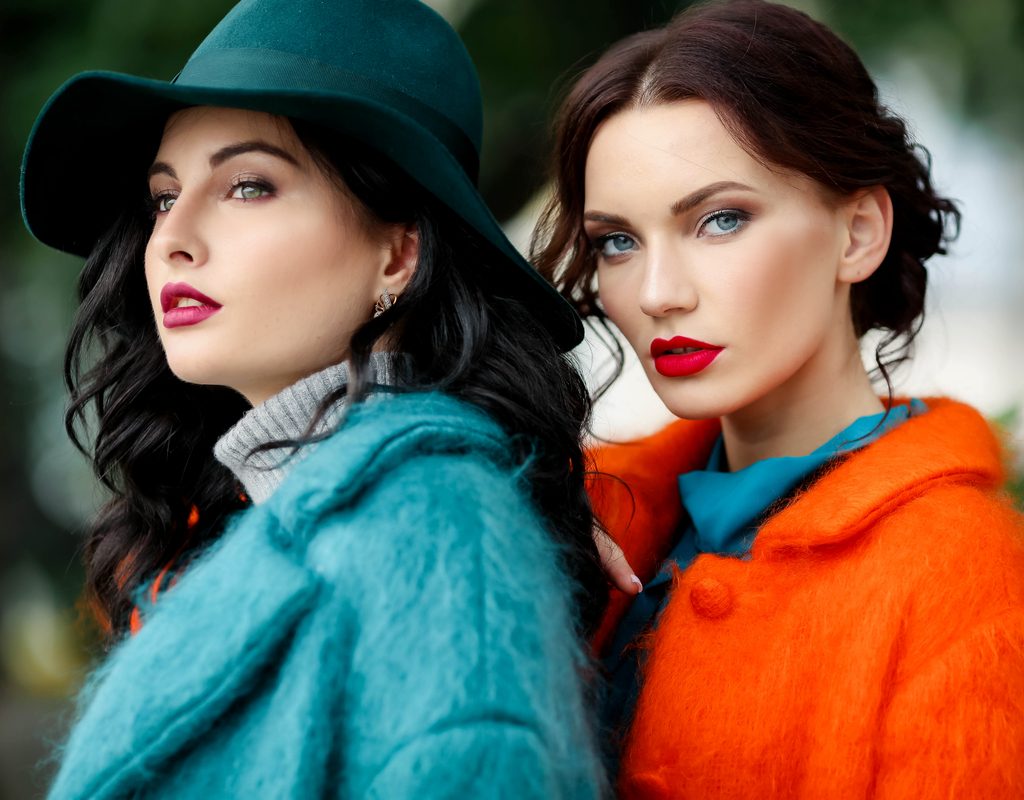 Two women in fall fashion and fall makeup.