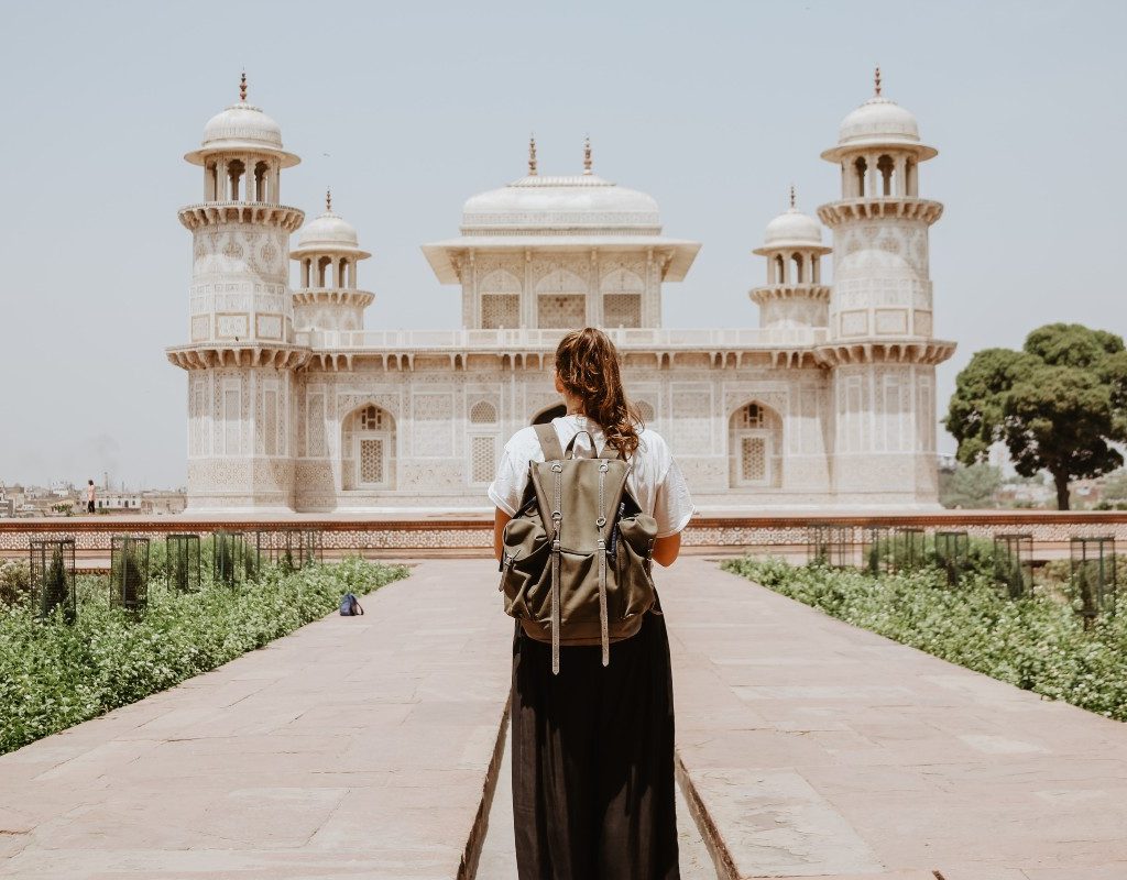 a solo traveler approaching Tomb of I’timād-ud-Daulah, Agra in India