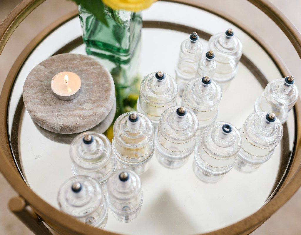 several suction cups for cupping next to a candle