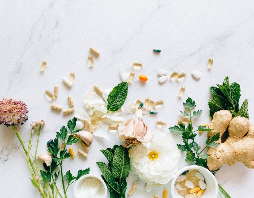 supplements on a white counter with plants