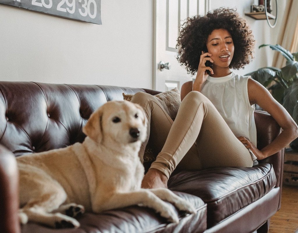 woman on couch with a yellow lab