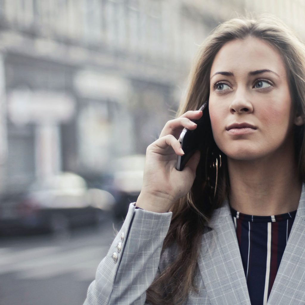 Woman talking on the phone outside
