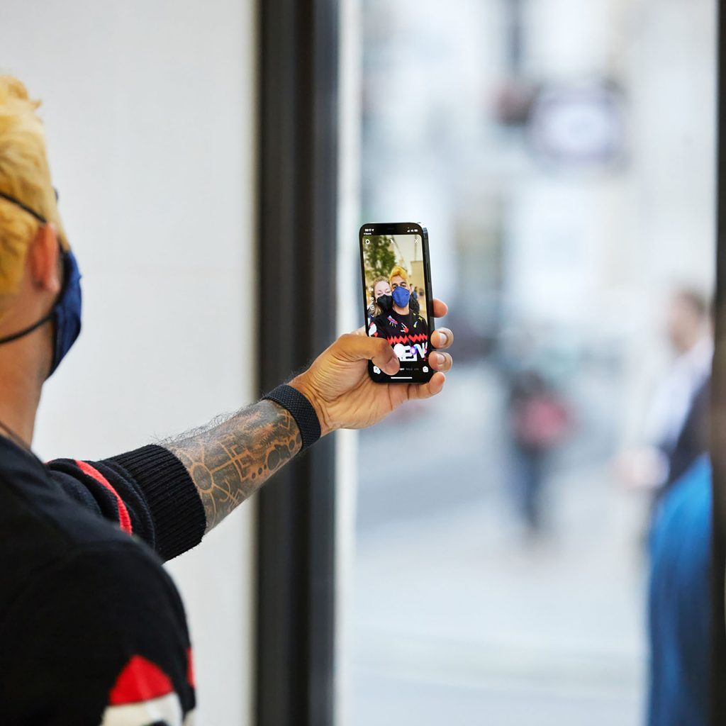 Customers taking a selfie with the new iPhone at the Apple store