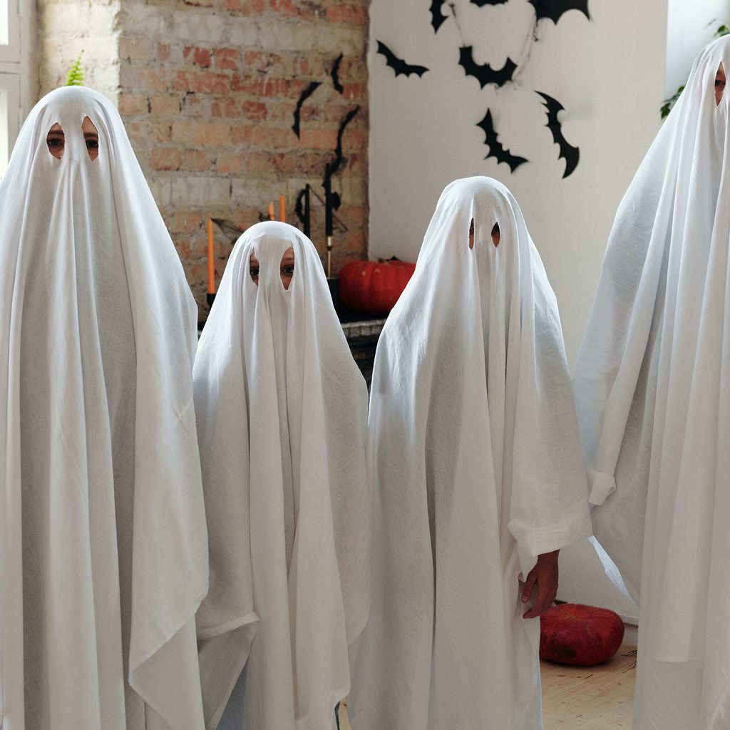 Family dressed up as ghosts for Halloween