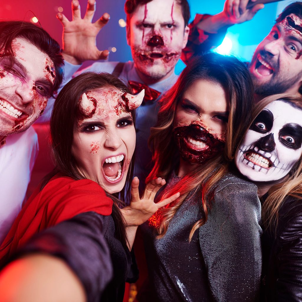 Group of friends wearing scary Halloween makeup