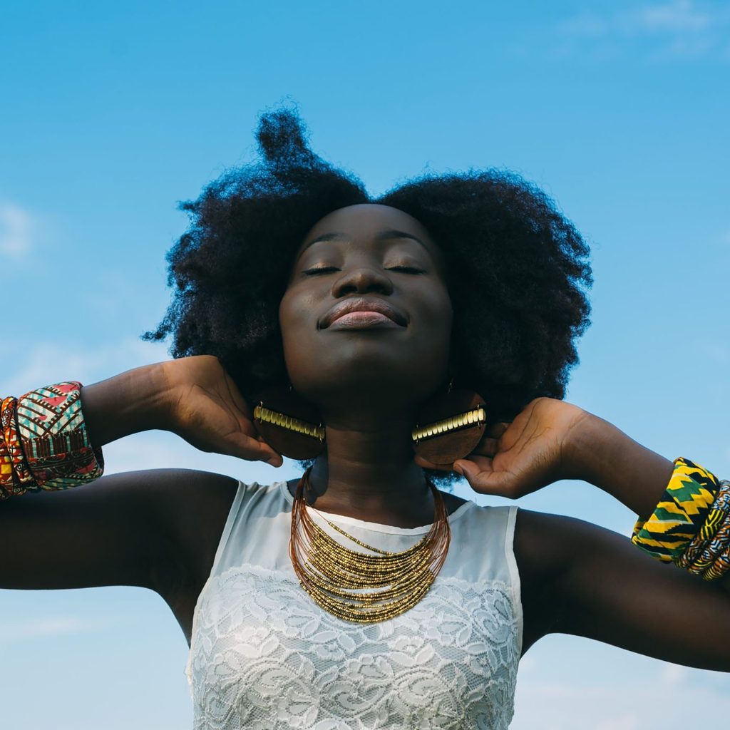 Happy woman wearing jewelry on a sunny day