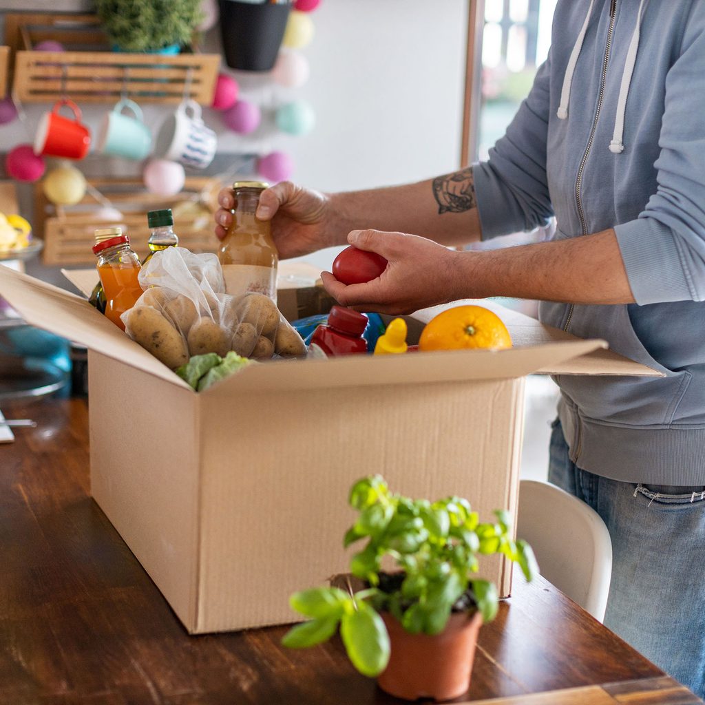 Man unpacking grocery delivery box
